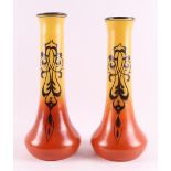 A pair of red and yellow glass Art Nouveau vases with long necks, circa 1900.