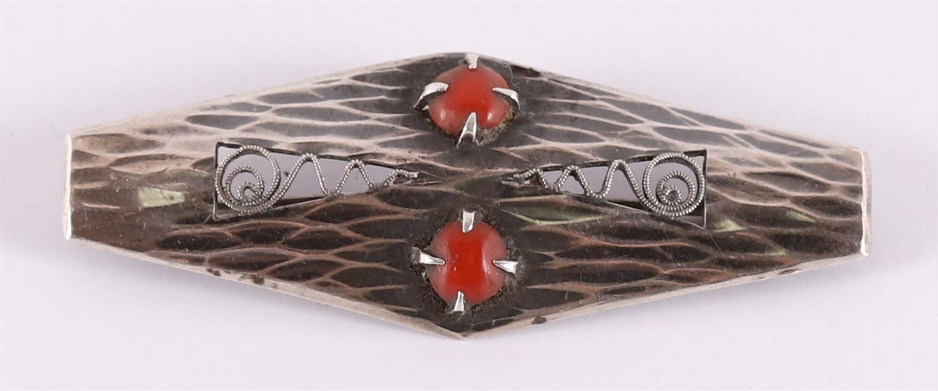 A hammered silver brooch with cabochon cut red corals. D.P.M. Gaillard