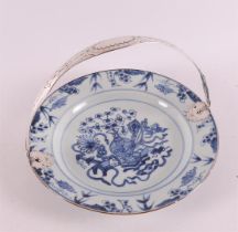 A blue/white porcelain plate with a silver handle from a later date, China, Kang