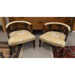 A pair of walnut bergères with yellow fabric upholstery, circa 1900