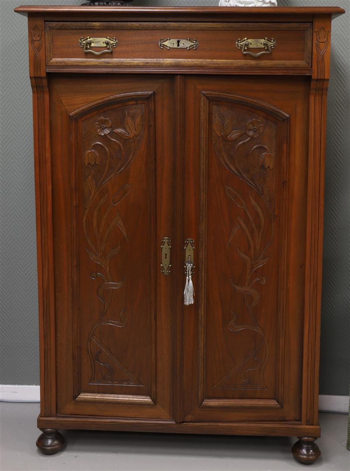 A two-door Art Nouveau vertico with a drawer above, Germany ca. 1900.