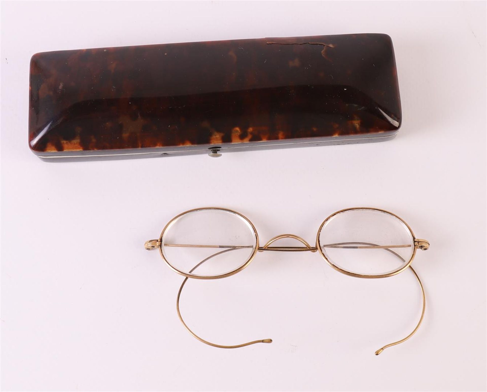 A rectangular tortoiseshell spectacle case containing glasses, late 19th century