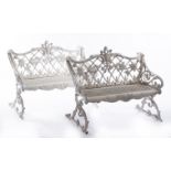 A pair of English cast-iron and white painted garden benches