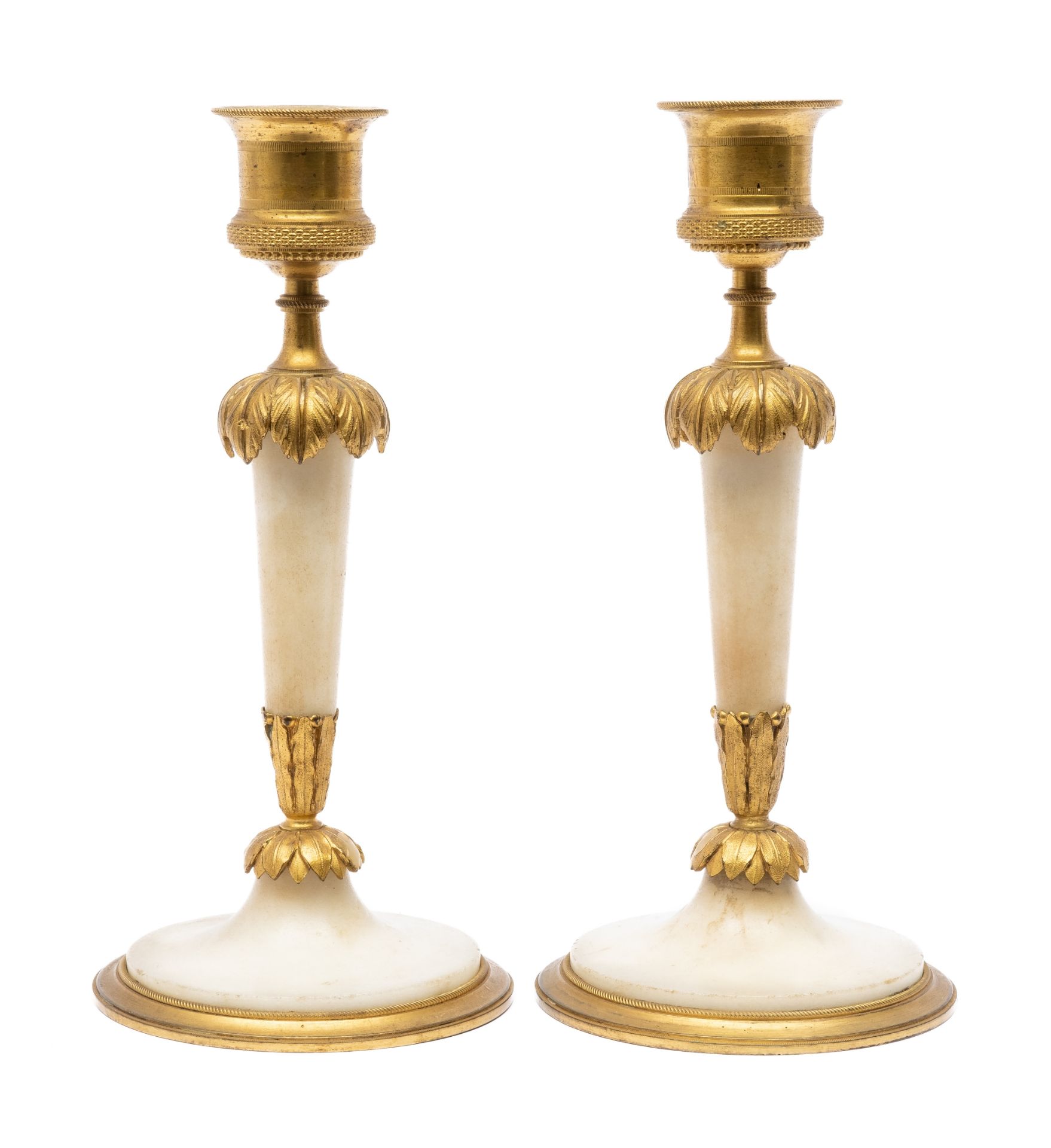 A pair of Louis XVI ormolu and alabaster candlesticks