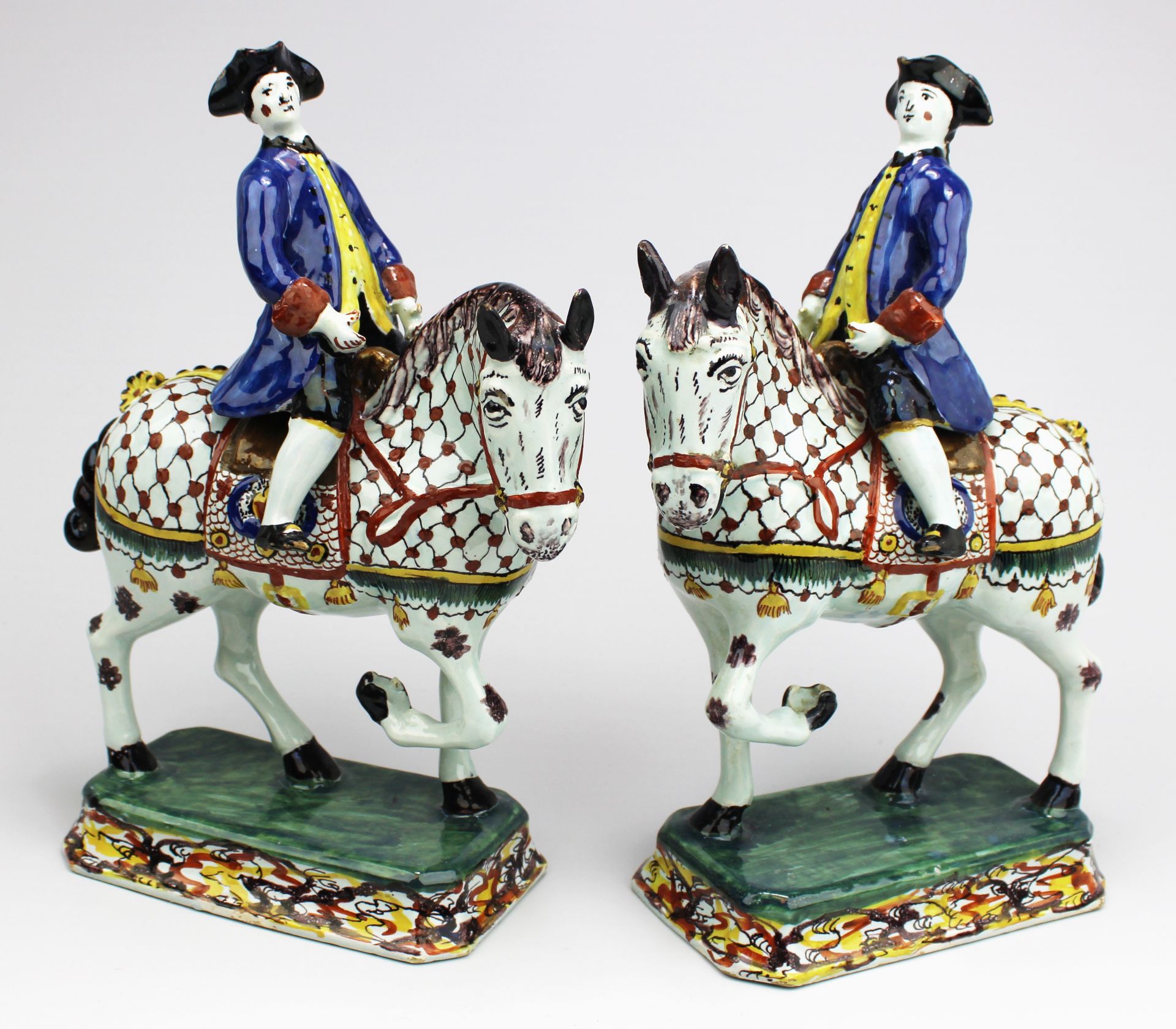 A pair of Delft polychrome pottery horse riders