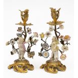 A pair of Louis XV ormolu and porcelain figural candlesticks