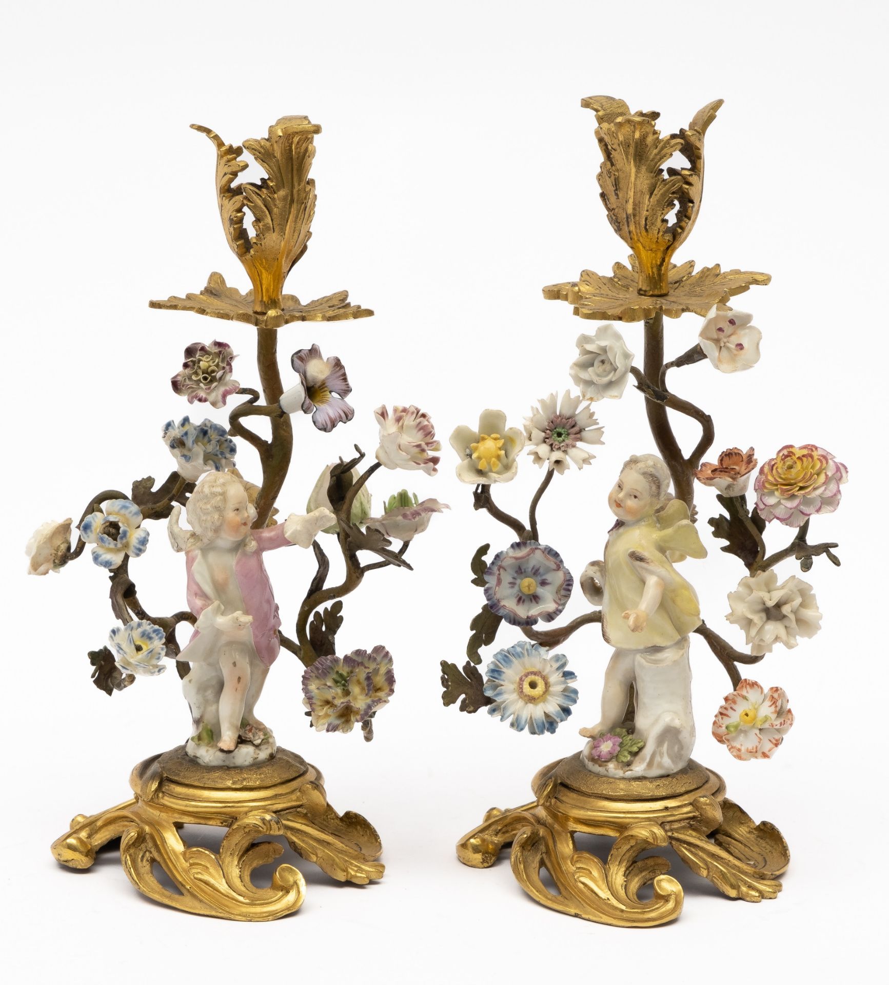 A pair of Louis XV ormolu and porcelain figural candlesticks