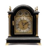 An Edwardian brass-mounted ebonised bracket clock