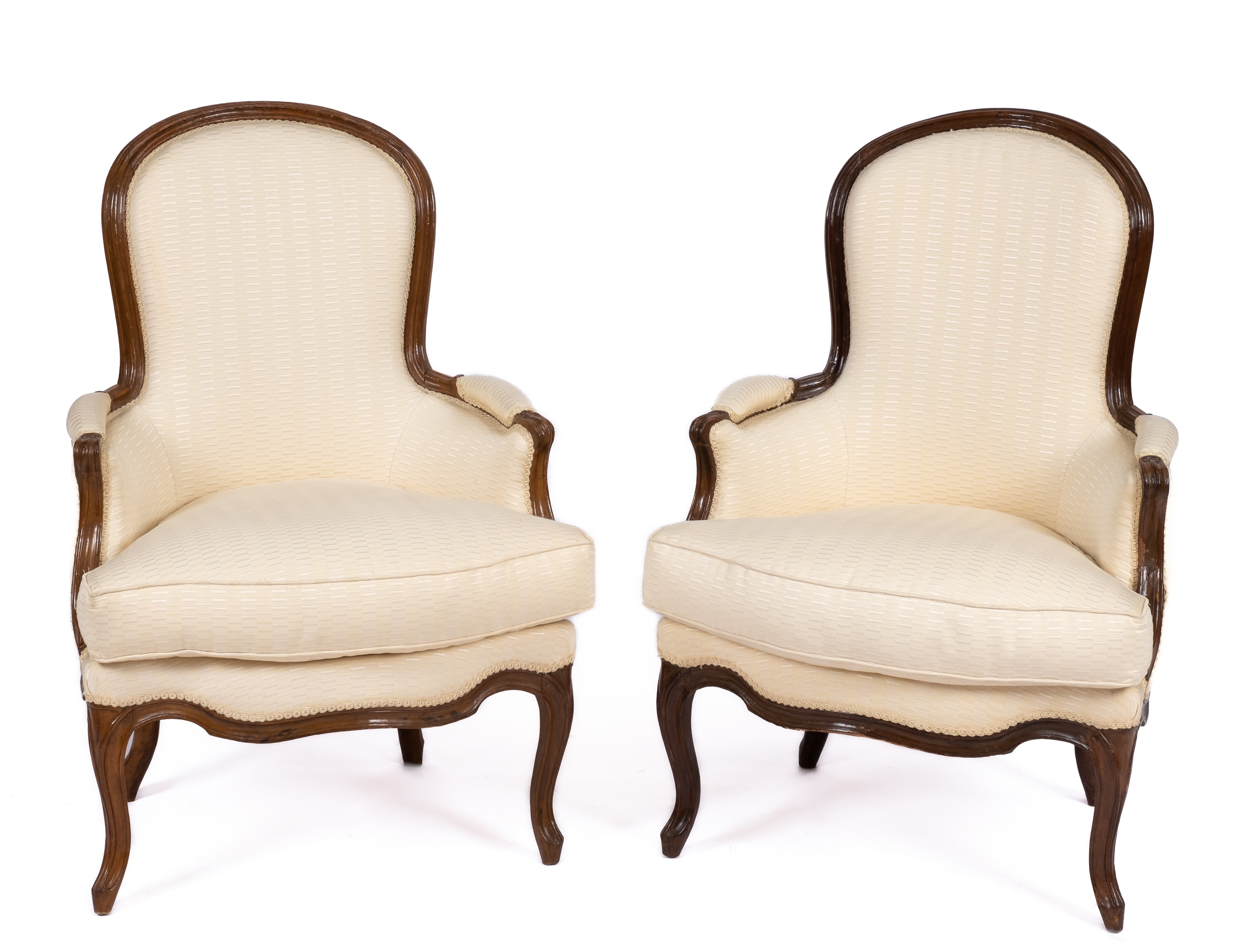 A pair of Louis XV carved beechwood bergères