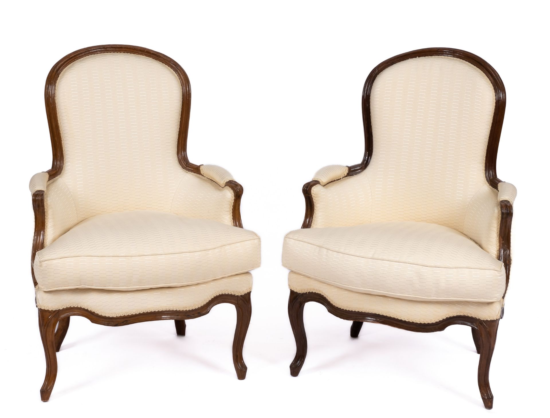 A pair of Louis XV carved beechwood bergères