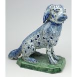 A large Delft pottery figure of a sitting dog