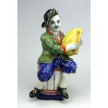 A large Delft polychrome pottery figure of a bagpipe player