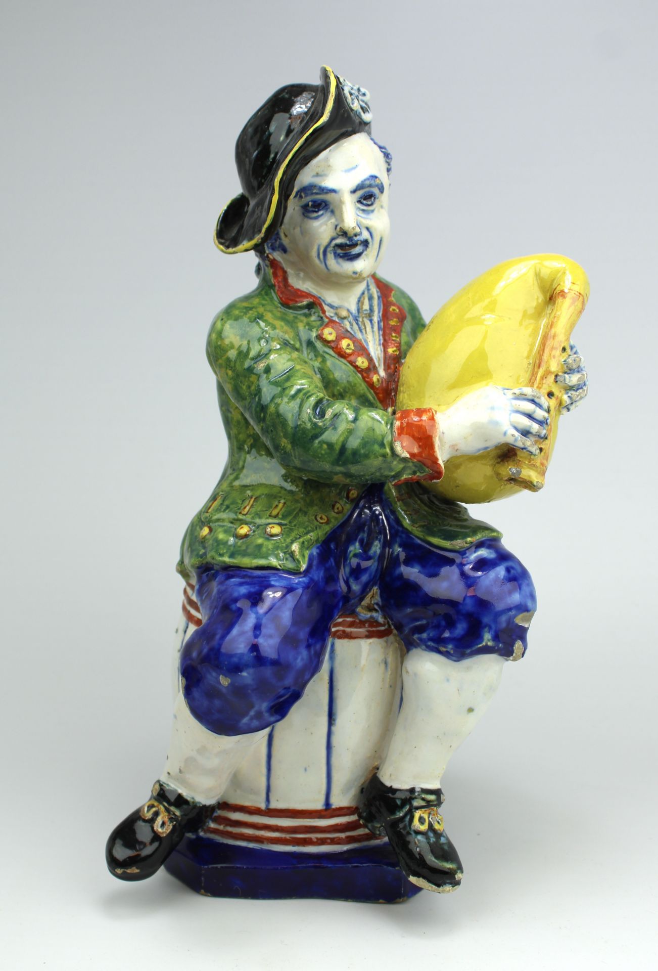 A large Delft polychrome pottery figure of a bagpipe player