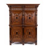 A Southern-Netherlands carved oak, ebony and ebonised four-door cupboard