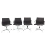 A Collection of 4 Charles and Ray Eames Arm Chairs