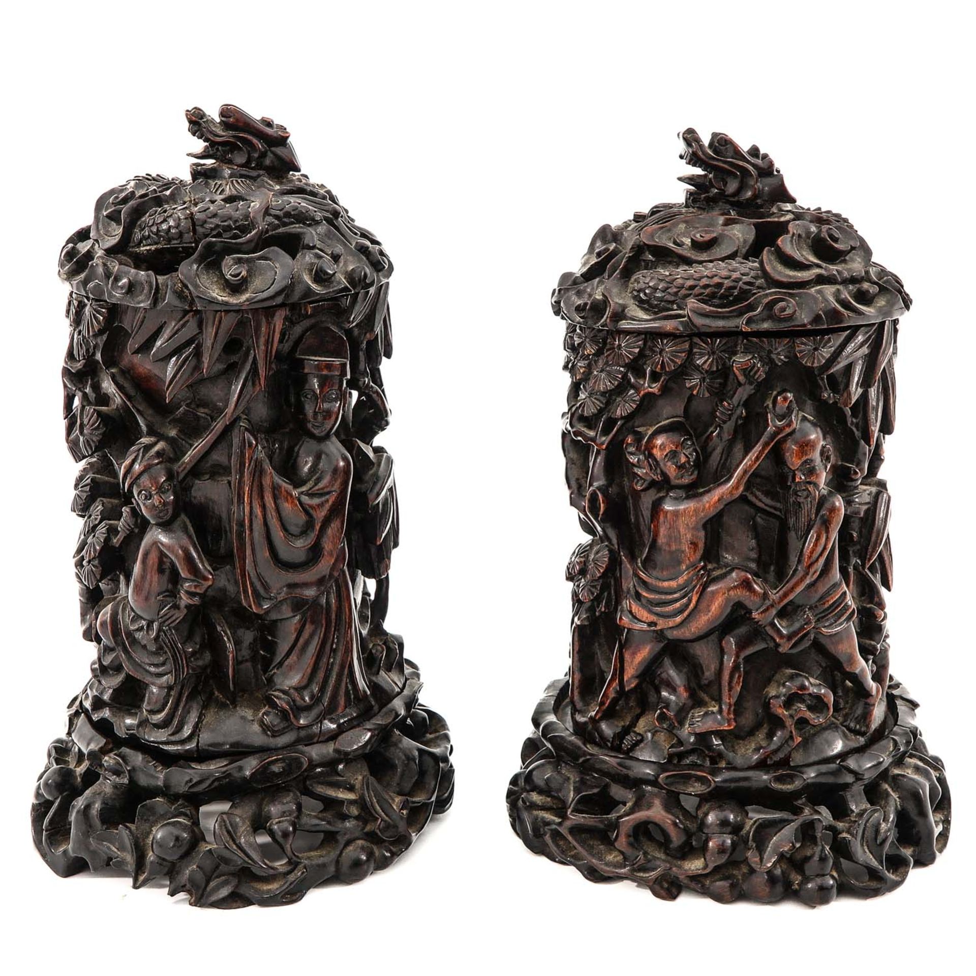 A Pair of Carved Wood Brush Pots with Covers