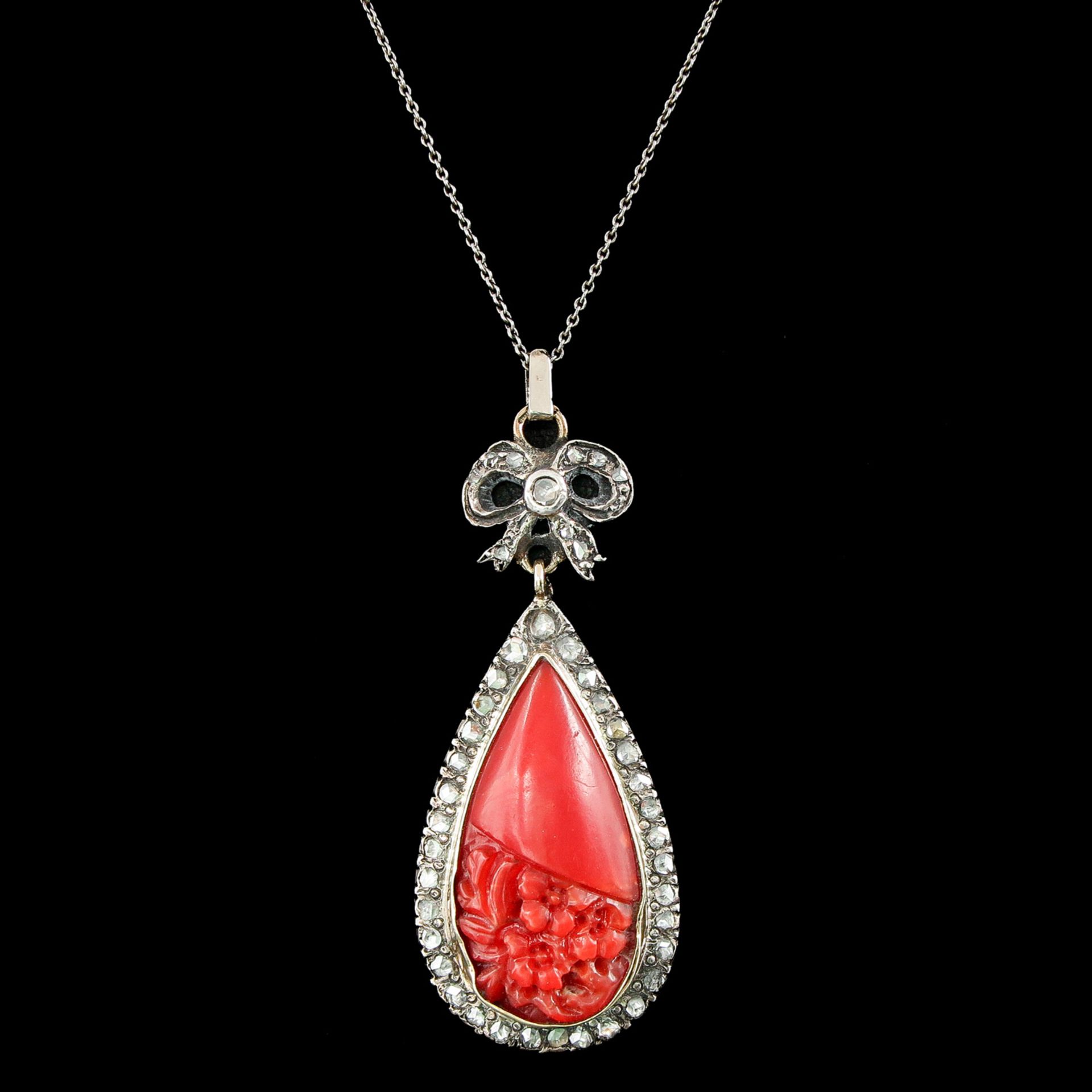 A Carved Red Coral Pendant with Diamonds