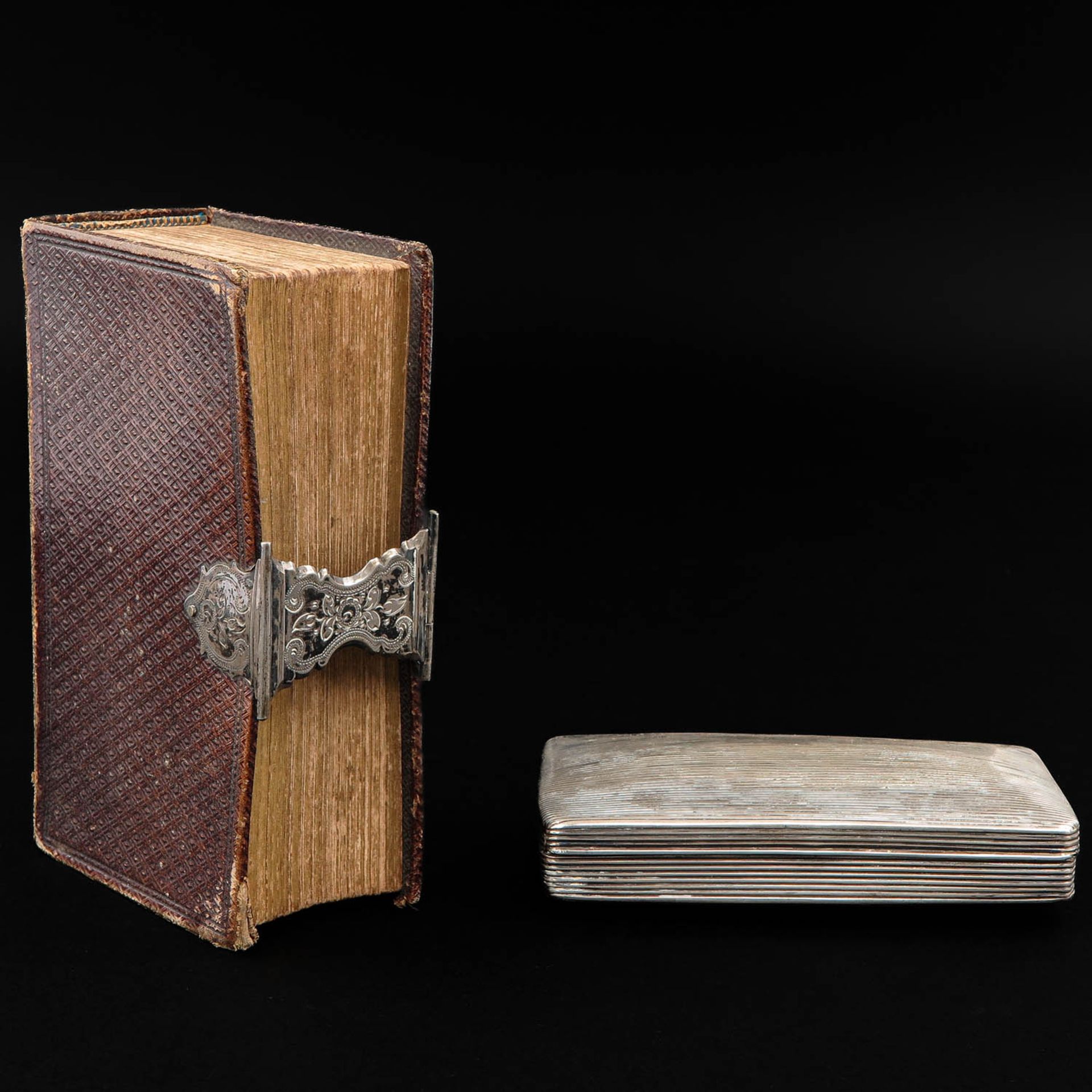 A Bible with Silver Clasp and Silver Tobacco Box