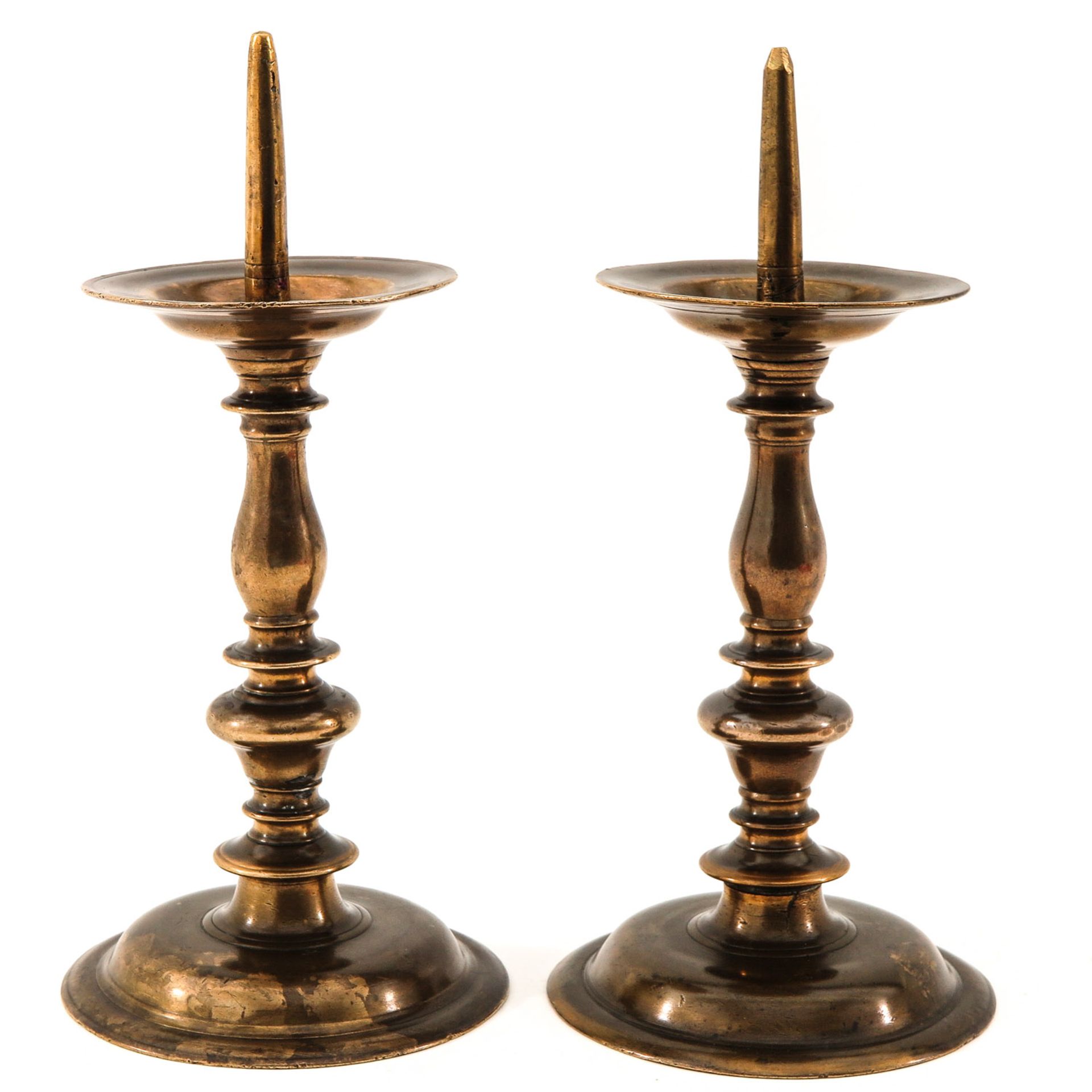 A Pair of 17th Century Bronze Pen Candlesticks