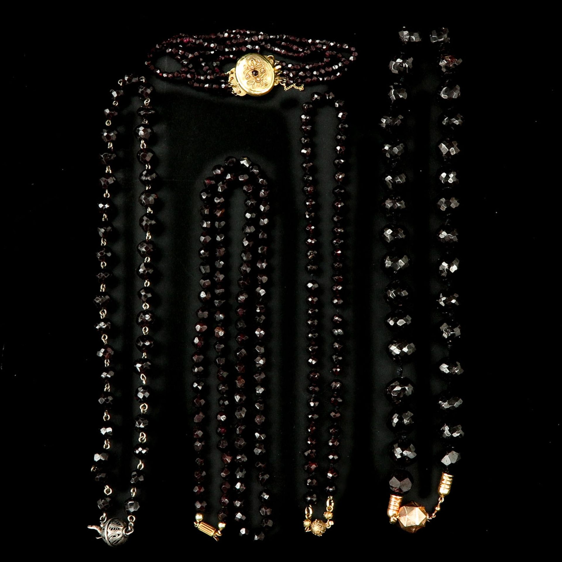 A Collection of 4 Garnet Necklaces and 1 Bracelet