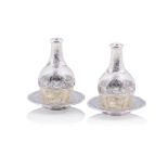 A pair of bottles and tall footed salvers