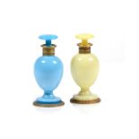 Two perfume bottles and stoppers