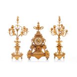 A Napoleon III garniture, Comprising of table top clock and pair of six branch candelabra, Gilt