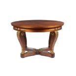 An Empire style centre table, Solid and veneered mahogany of applied gilt bronze elements, resting