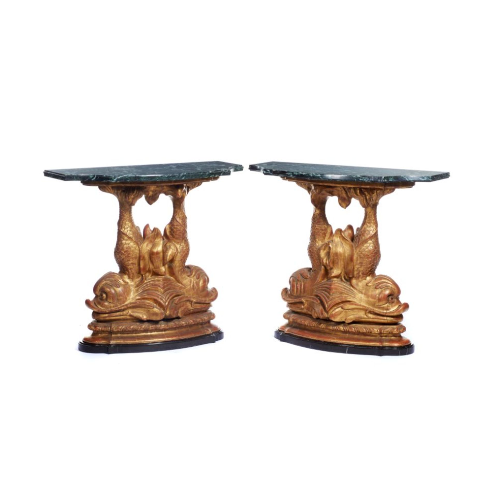 A pair of consoles, Carved and gilt wood, Black and green marble tops on two dolphin shaped