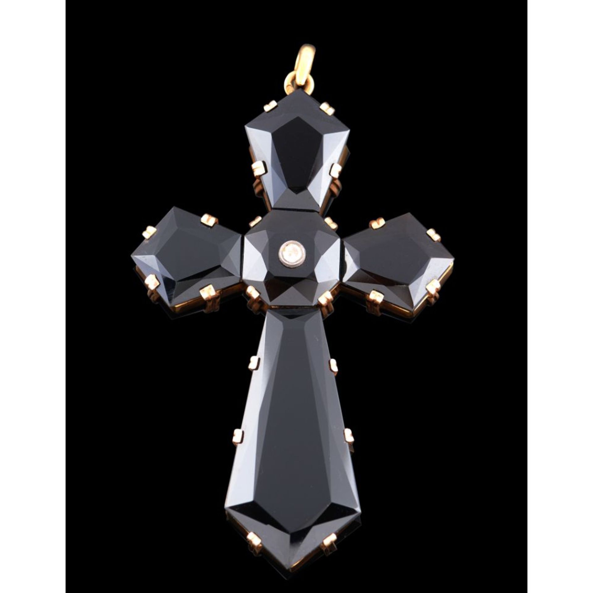 A cross shaped pendant, Gold 800/000, Applied onyx plaques, Set with brilliant cut diamond, Oporto