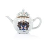 An armorial teapot and a cover