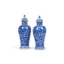 A pair of blue and white vases and covers