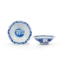 A pair of blue and white footed bowls