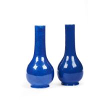 A pair of blue monochrome bottle vases