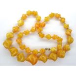 Shaped graduated amber bead necklace, L: 60 cm, largest bead L: 24 mm. P&P Group 1 (£14+VAT for