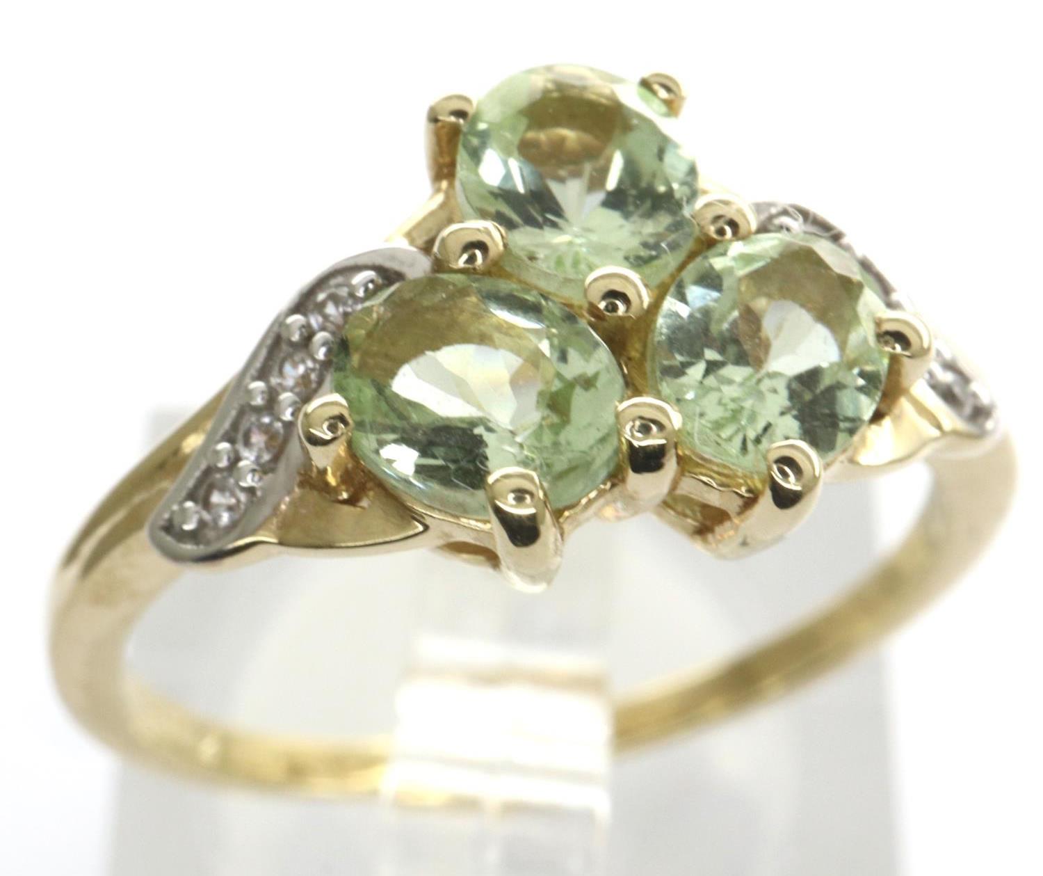 10ct gold emerald trilogy ring set with CZ stones, size N/O, 2.4g. P&P Group 1 (£14+VAT for the