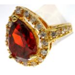 10ct gold ring set with a pear shaped garnet and CZ shoulders, size Q, 5.5g. P&P Group 1 (£14+VAT