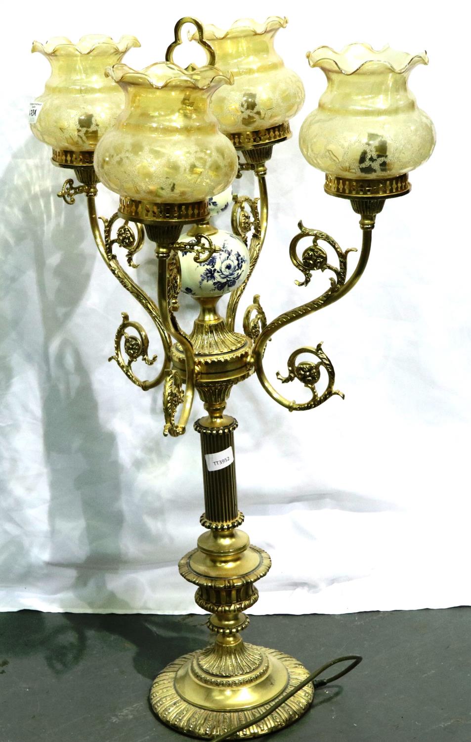 Large brass and ceramic three branch lamp with glass shade, H: 85 cm. All electrical items in this