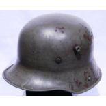 WWI German model 1917 Stahlhelm retaining most of its original green paint, indistinct stamp to left