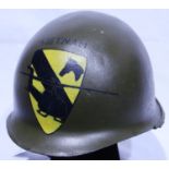 An American Vietnam war period M1 helmet, later painted with 1st Cavalry Division emblem. P&P