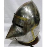 A full size steel reproduction knights helmet with visor, one rivet missing. P&P Group 2 (£18+VAT