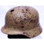 WWII period German Afrika Korps M40 helmet, large circular hole at front, rust and pitting