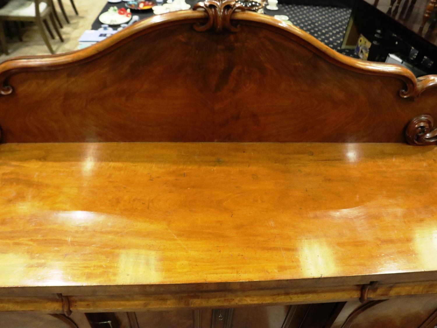 A 19th century flame mahogany buffet, having three drawers above four locking cupboards and carved - Image 2 of 5