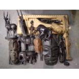 Mixed tribal carved figures and animals with two wall masks, largest H: 44 cm. Not available for