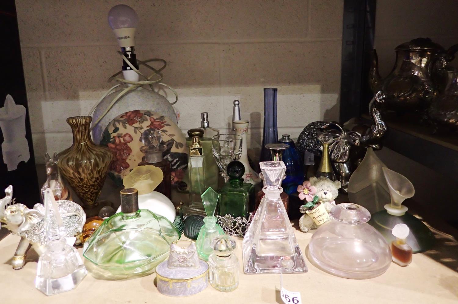 Quantity of mixed ceramics and glass, mainly empty perfume bottles including Jean Paul Gaultier. Not