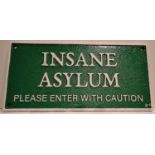 Cast iron Insane Asylum sign, W: 30 cm. P&P Group 1 (£14+VAT for the first lot and £1+VAT for
