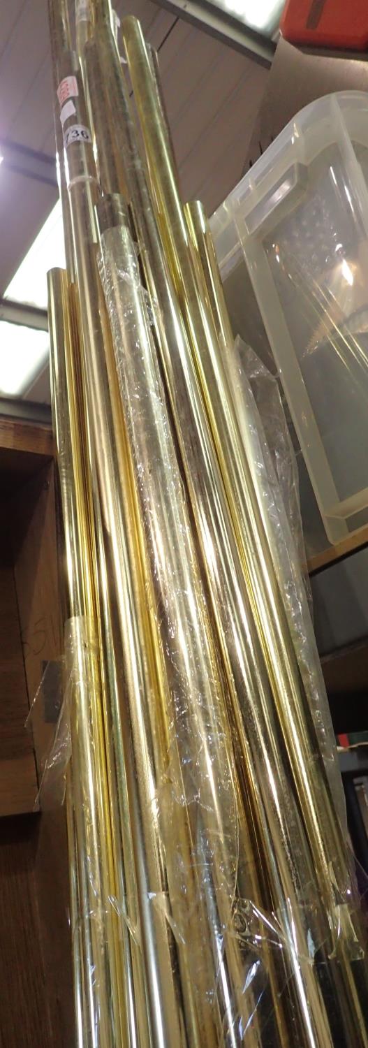 Twenty pieces of brass plated/coloured tubing, mixed lengths, largest L: 1800 mm. Not available