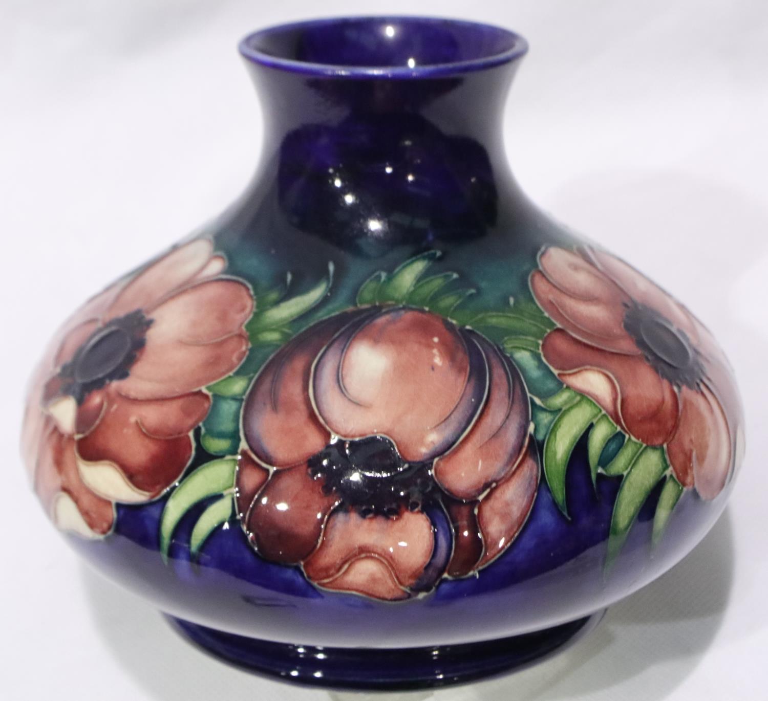 A Moorcroft squat form vase in the Pansies pattern, H: 12 cm, boxed, no cracks or chips. P&P Group 2