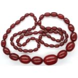 Cherry amber bead necklace, L: 100 cm, largest bead L: 30 mm, 89g. Amber marbles when backlit,