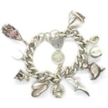 Heavy gauge 925 silver charm bracelet with hallmarked padlock clasp and eleven charms, bracelet L: